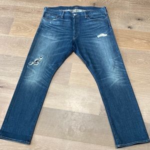 Medium wash classic polo denim with a few rips .